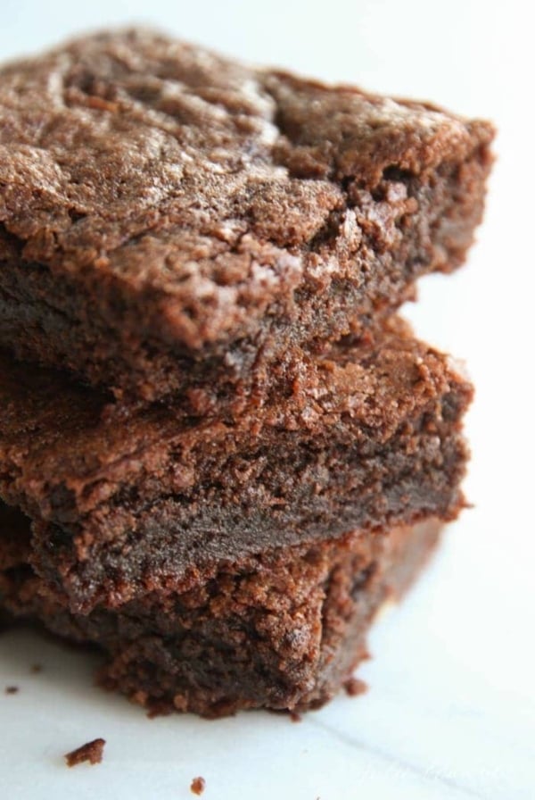 A close up of a stack of cut brownies.