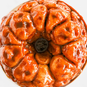 A sticky, glazed monkey bread ring glistening with a rich caramelized coating delights the senses.