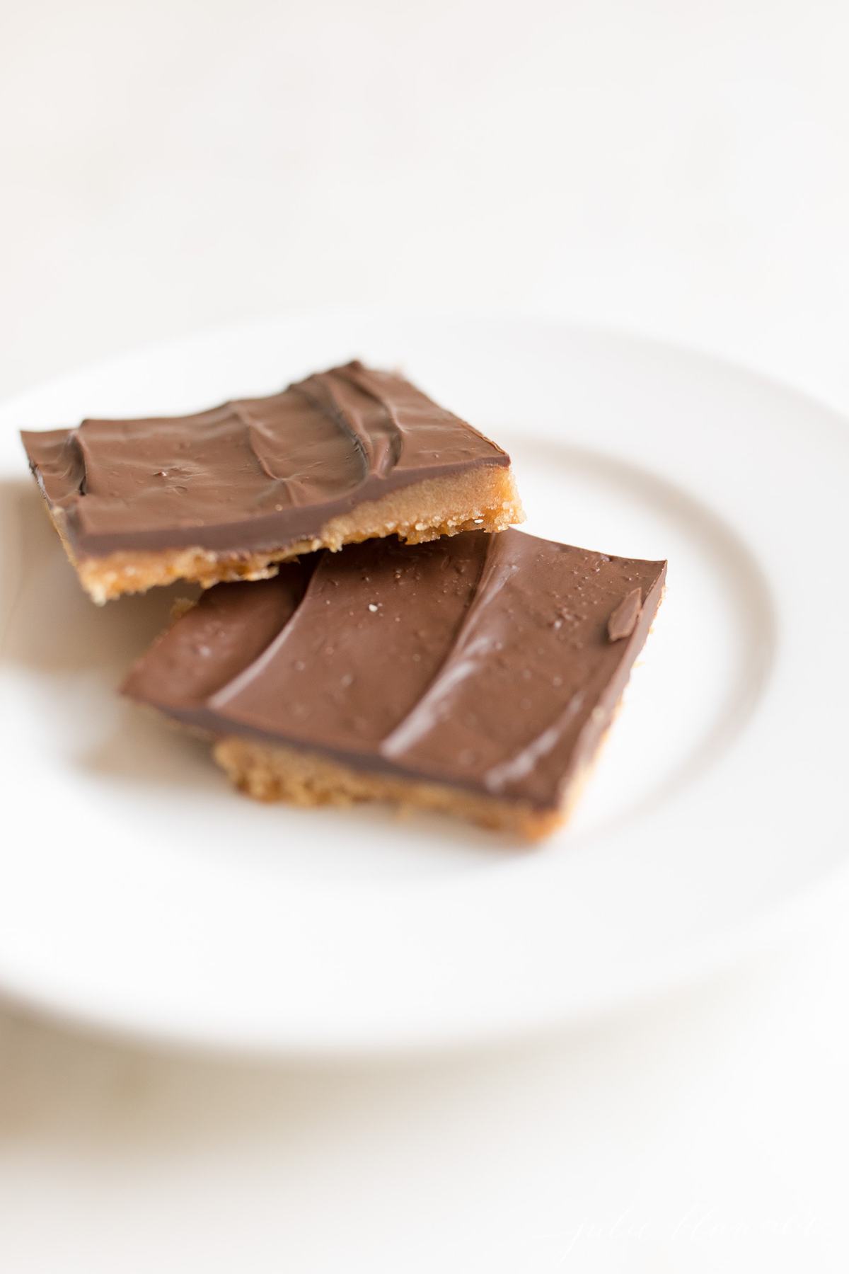 Christmas crack saltine toffee on a white plate 