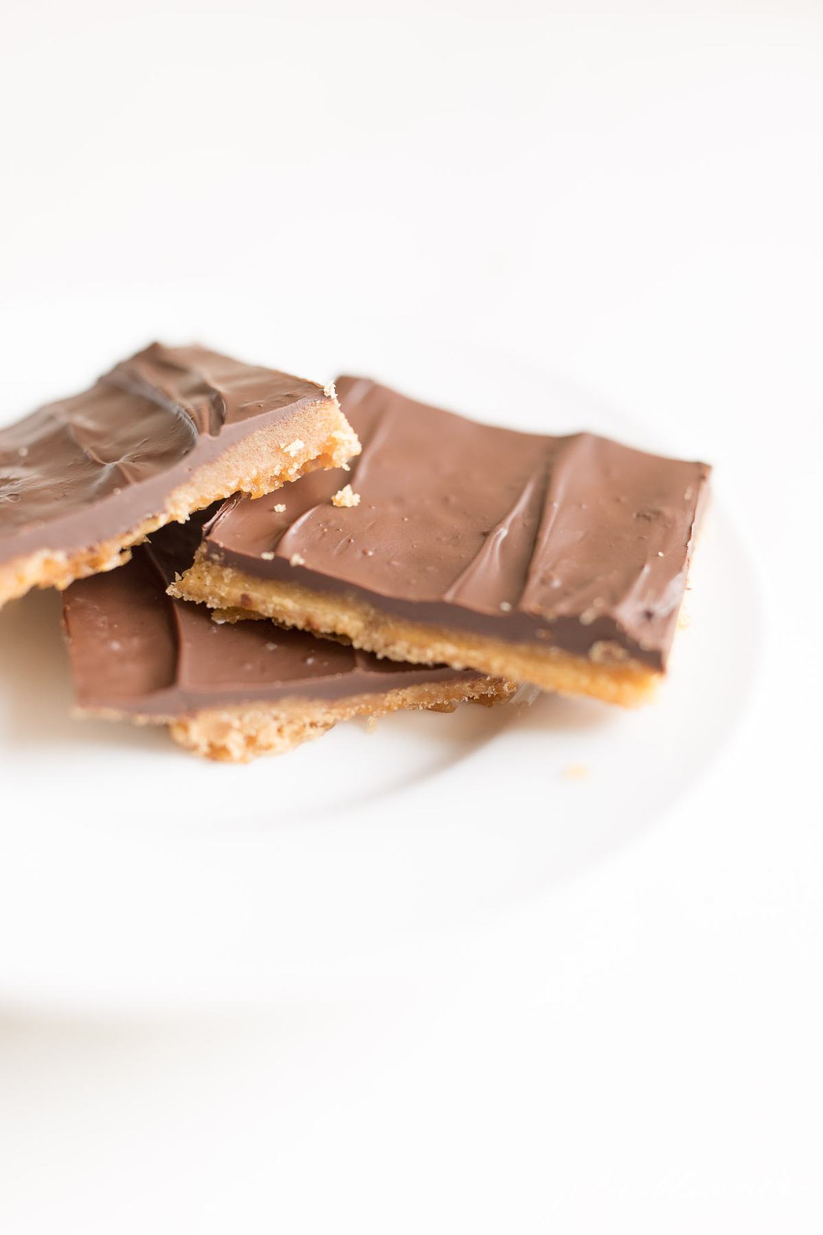 cracker toffee pieces on a white plate