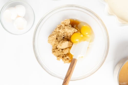 A bowl full of ingredients for a caramel pecan pie recipe.