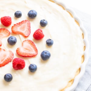 A close up of a fruit pizza with cream cheese fruit pizza icing on top.