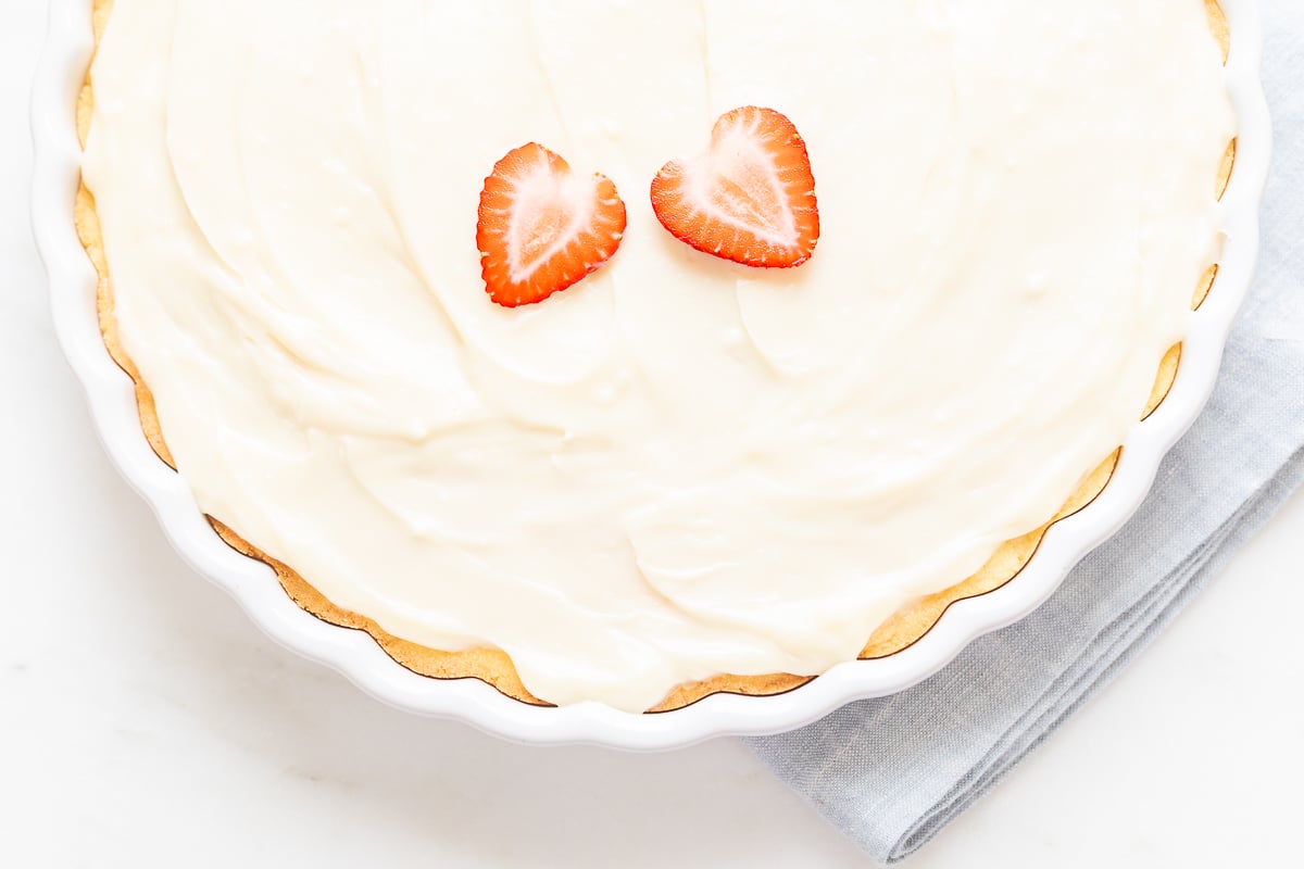 A close up of a fruit pizza with cream cheese fruit pizza icing on top.