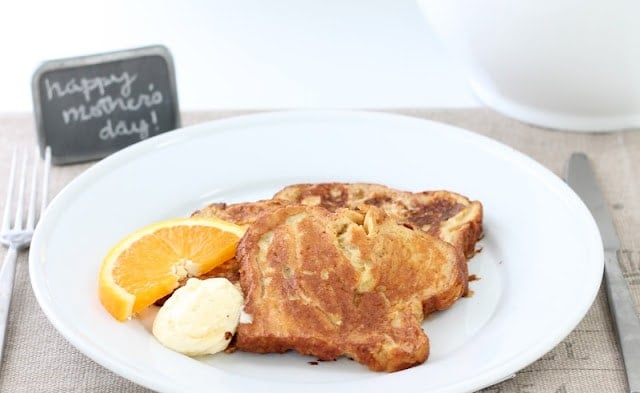 Apple Fritter French Toast served in. a white plate with butter