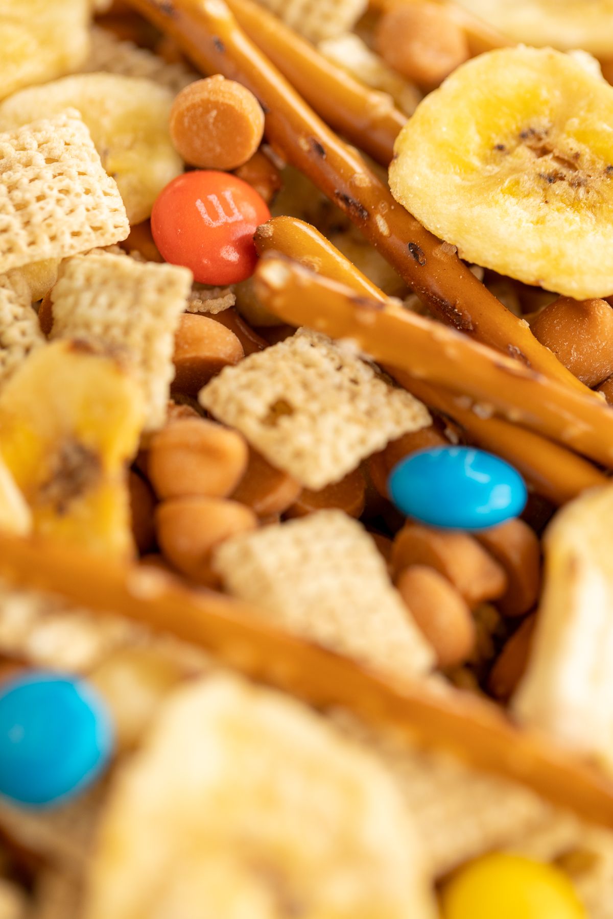 trail mix with m&ms, butterscotch chips and pretzel sticks