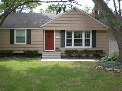 Black shutters on a brown house.