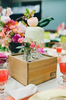 A close up of a cake with flowers in the background