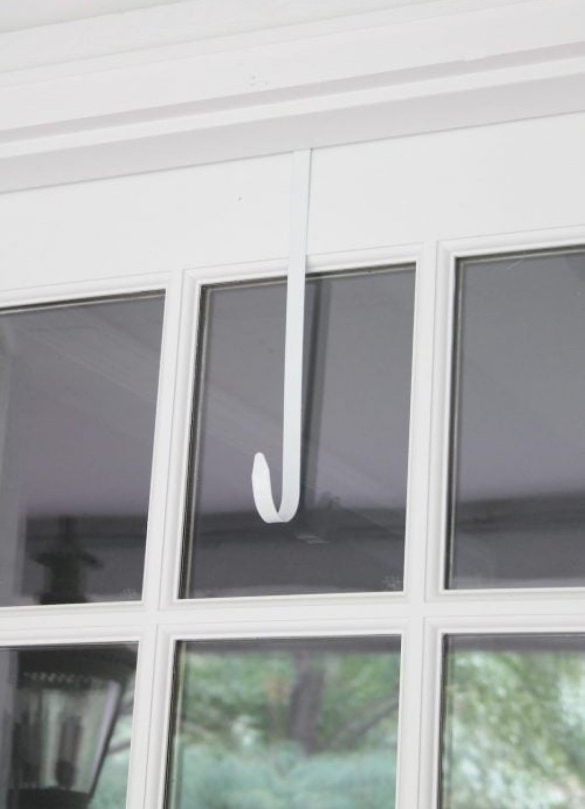 A front door with glass window panes, and a wreath hanger waiting for a wreath.