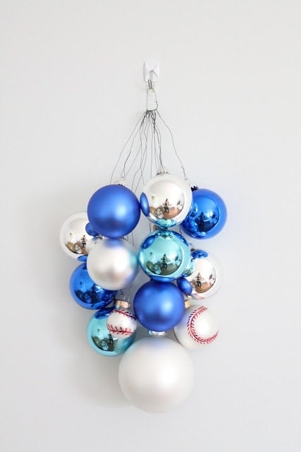 Blue, silver, and baseball ornaments hanging on the wall.