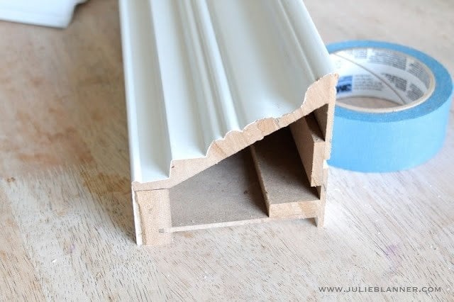 A close up of a white wall mount shelf