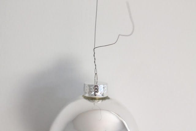 A silver ornament hanging on the wall