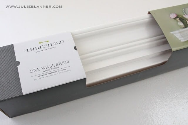 A close up of a white wall mount shelf from target