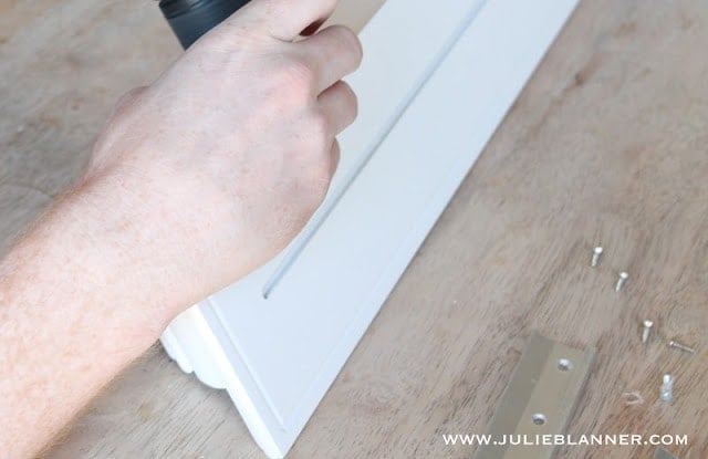 A close up of a white wall mount shelf