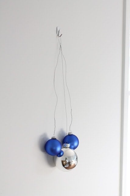 Blue, silver, and baseball ornaments hanging on the wall.