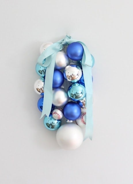 Blue, silver, and baseball ornaments hanging on the wall.