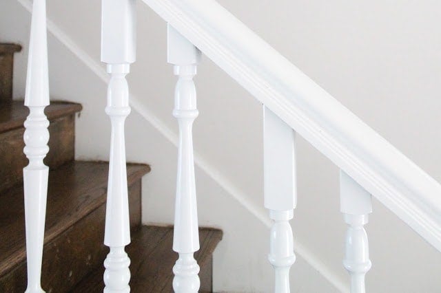 White stairs with wooden tops and white hand railings.