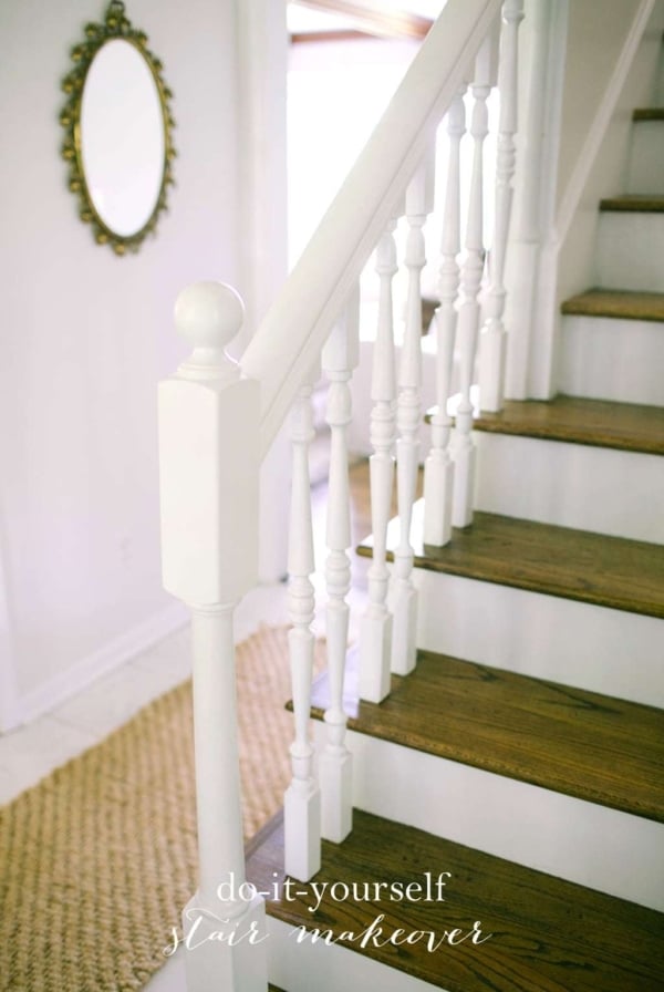 White stairs with wooden tops and white hand railings.