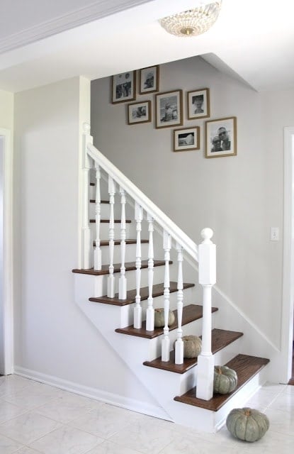 White stairs with wooden tops and white hand railings.