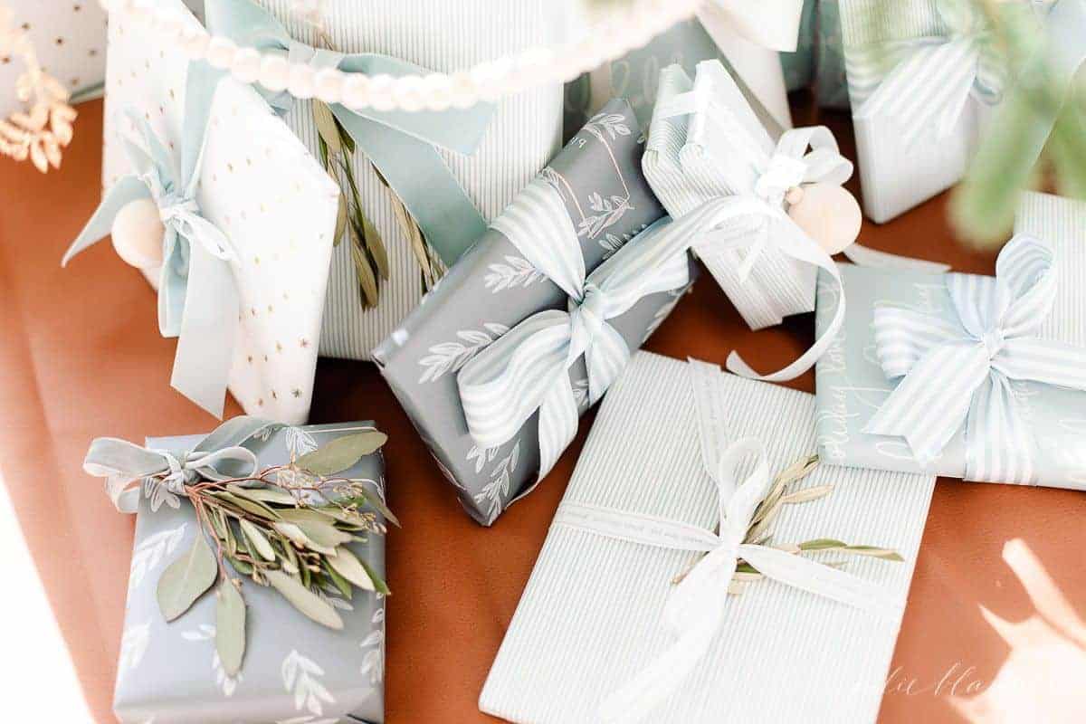 Blue and white wrapped christmas gifts wrapped under the tree.