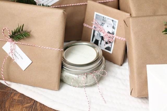 Brown kraft paper wrapped presents tied with baker\'s twine and decorated with old family photos.