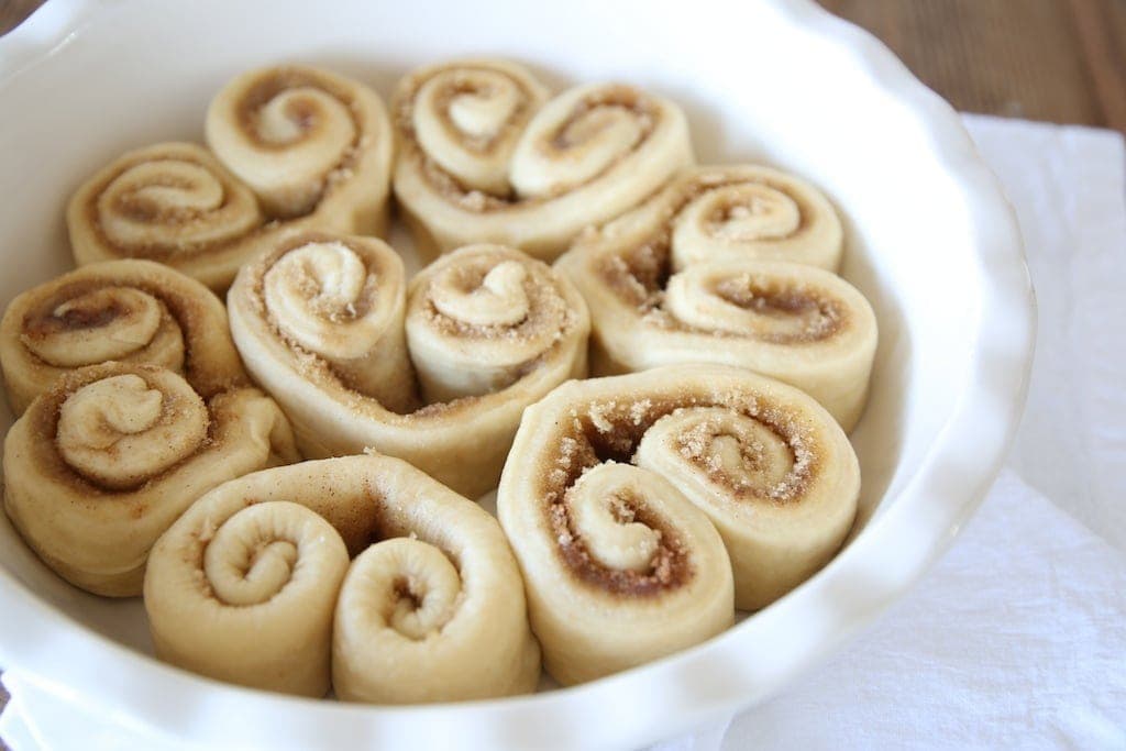 The heart cinnamon rolls in a baking dish ready to be baked