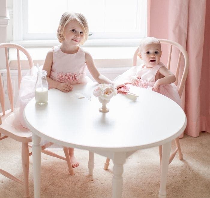 Two little girls sitting at a table