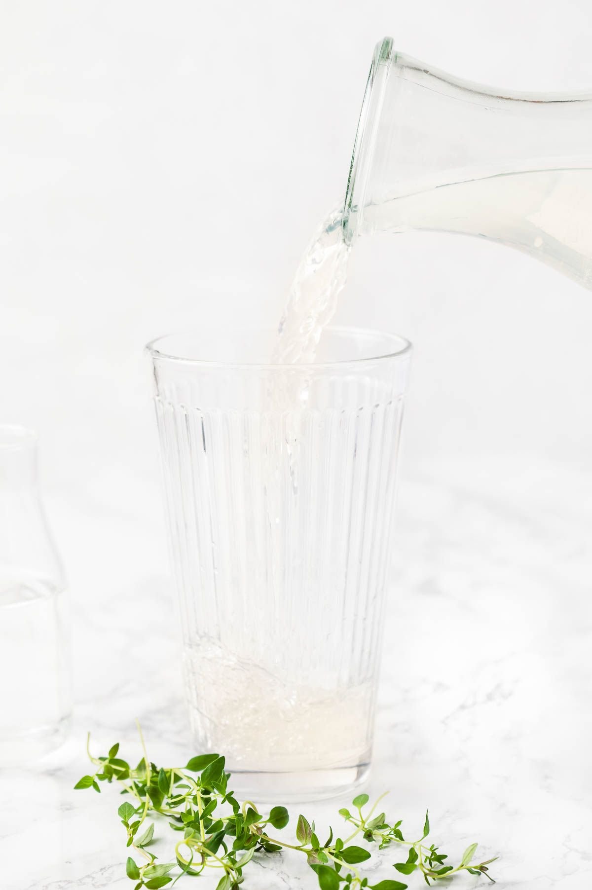 A vodka cocktail with lemonade being poured into a glass.