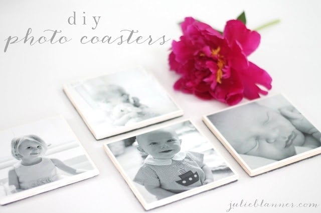 A close up of a flower next to photo coasters.