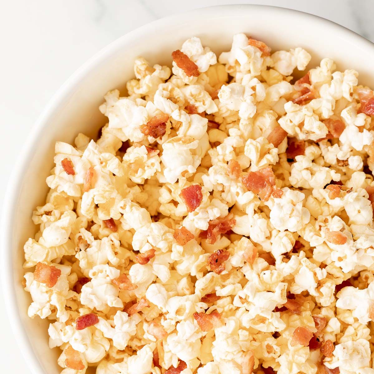 A white bowl filled with bacon popcorn