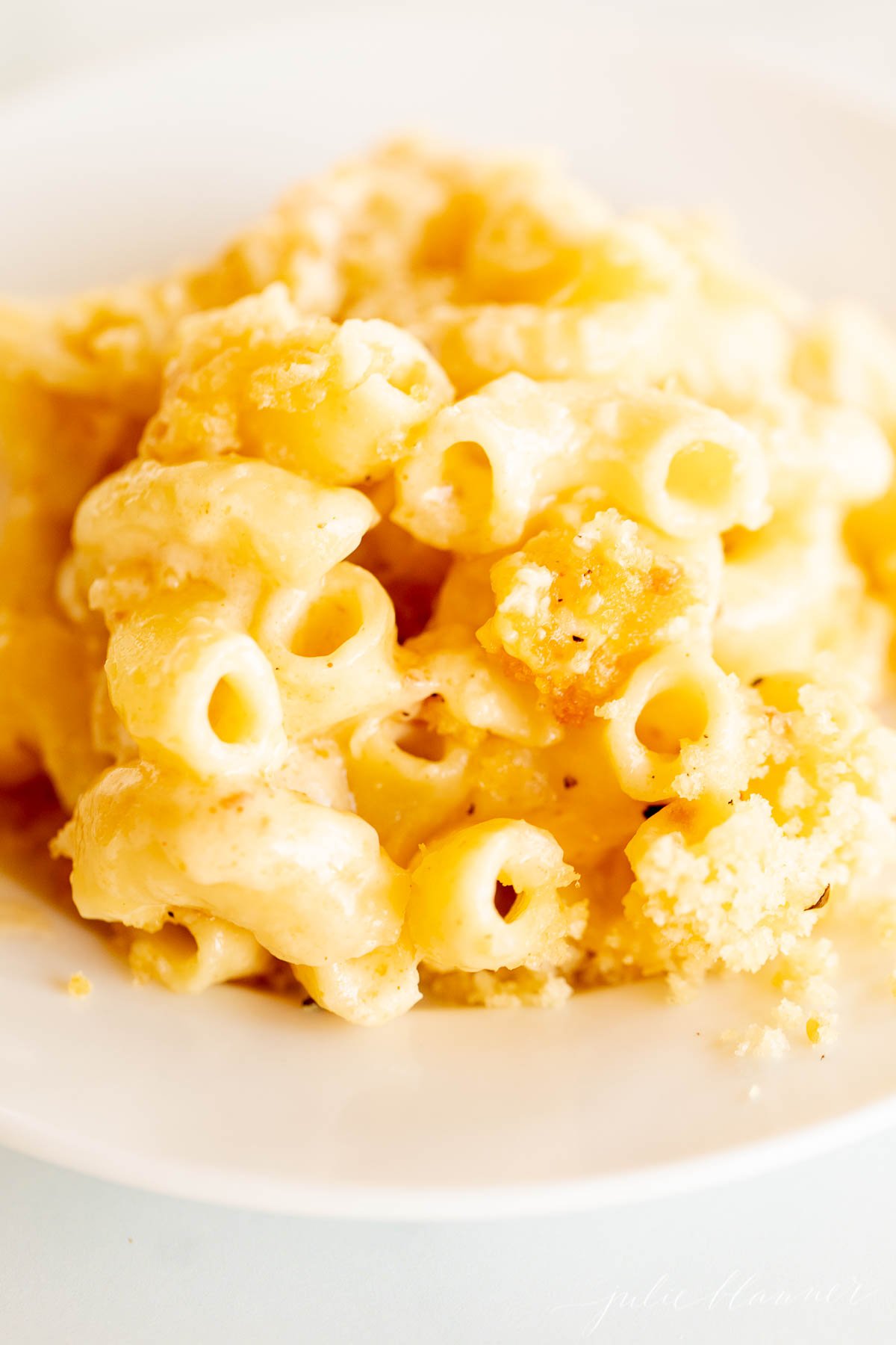 Baked macaroni and cheese on a white plate.