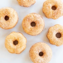 Cinnamon sugar donuts on a marble countertop.