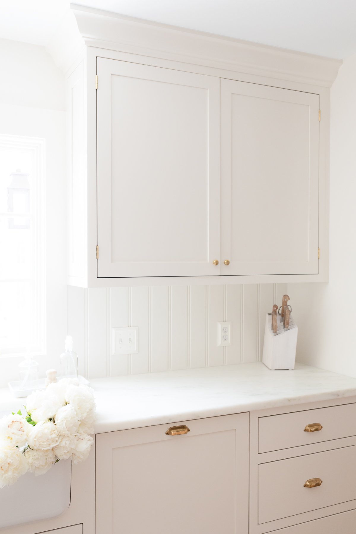 A cream kitchen with Danby marble countertops with an eased edge.