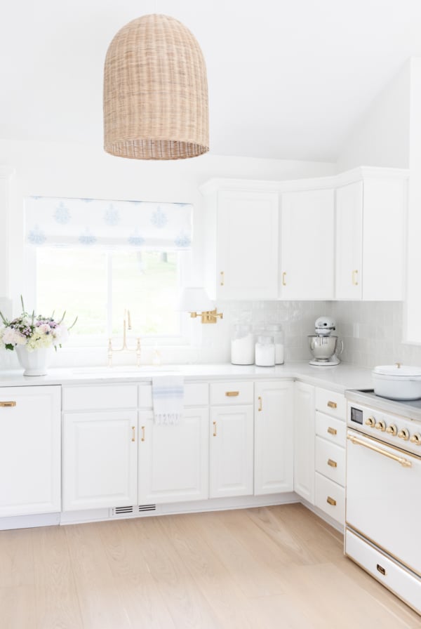 A white kitchen with white quartz countertops in a guide to carrara marble countertop alternatives.