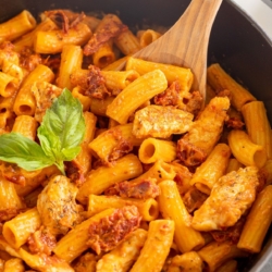 Sun dried tomato chicken pasta in a cast iron skillet.