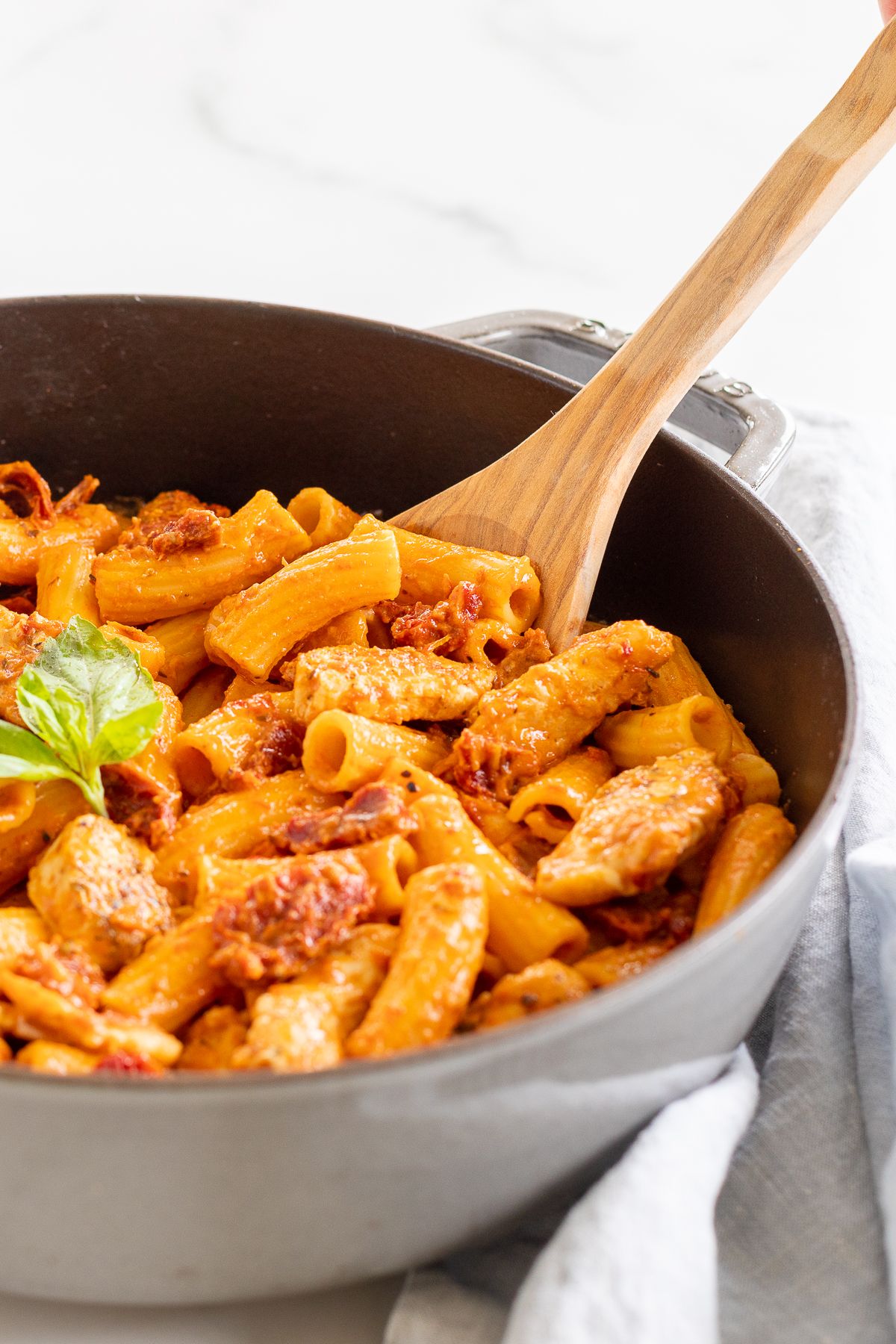 Sun dried tomato chicken pasta in a cast iron skillet.