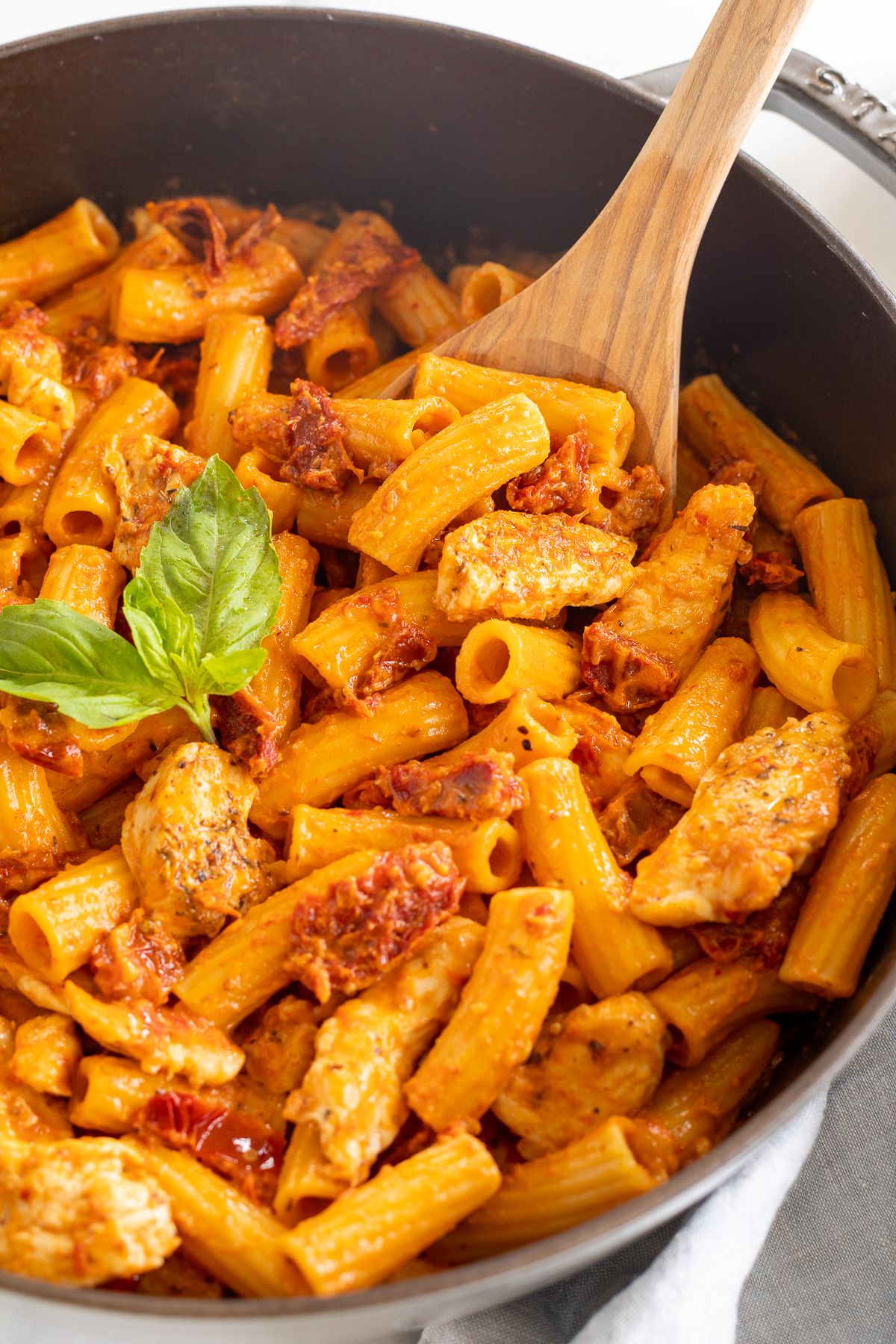 Sun dried tomato chicken pasta in a cast iron skillet.