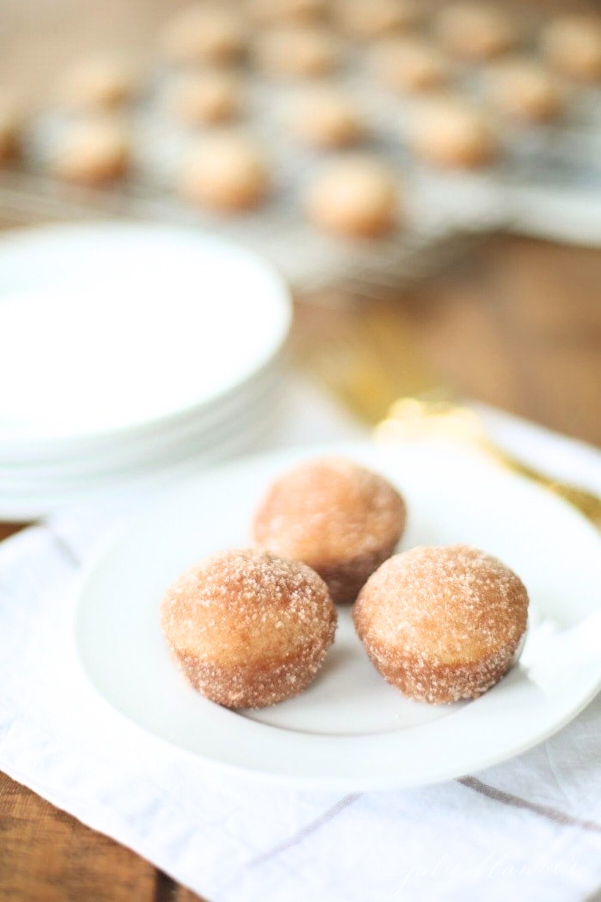 Apple cinnamon donut holes on a white plate