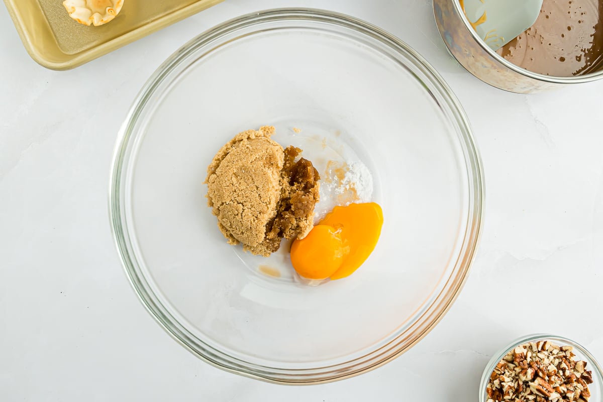 A bowl of cookie dough with a Mini Pecan Pie in it.