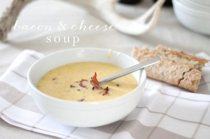 soup in white bowl next to baguette