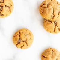 flourless peanut butter chocolate chip cookies scattered on marble counter