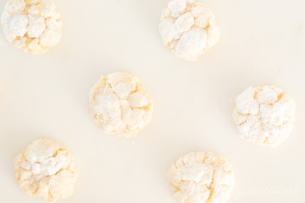 Top shot of crinkled cookies ready to eat, on a white surface.