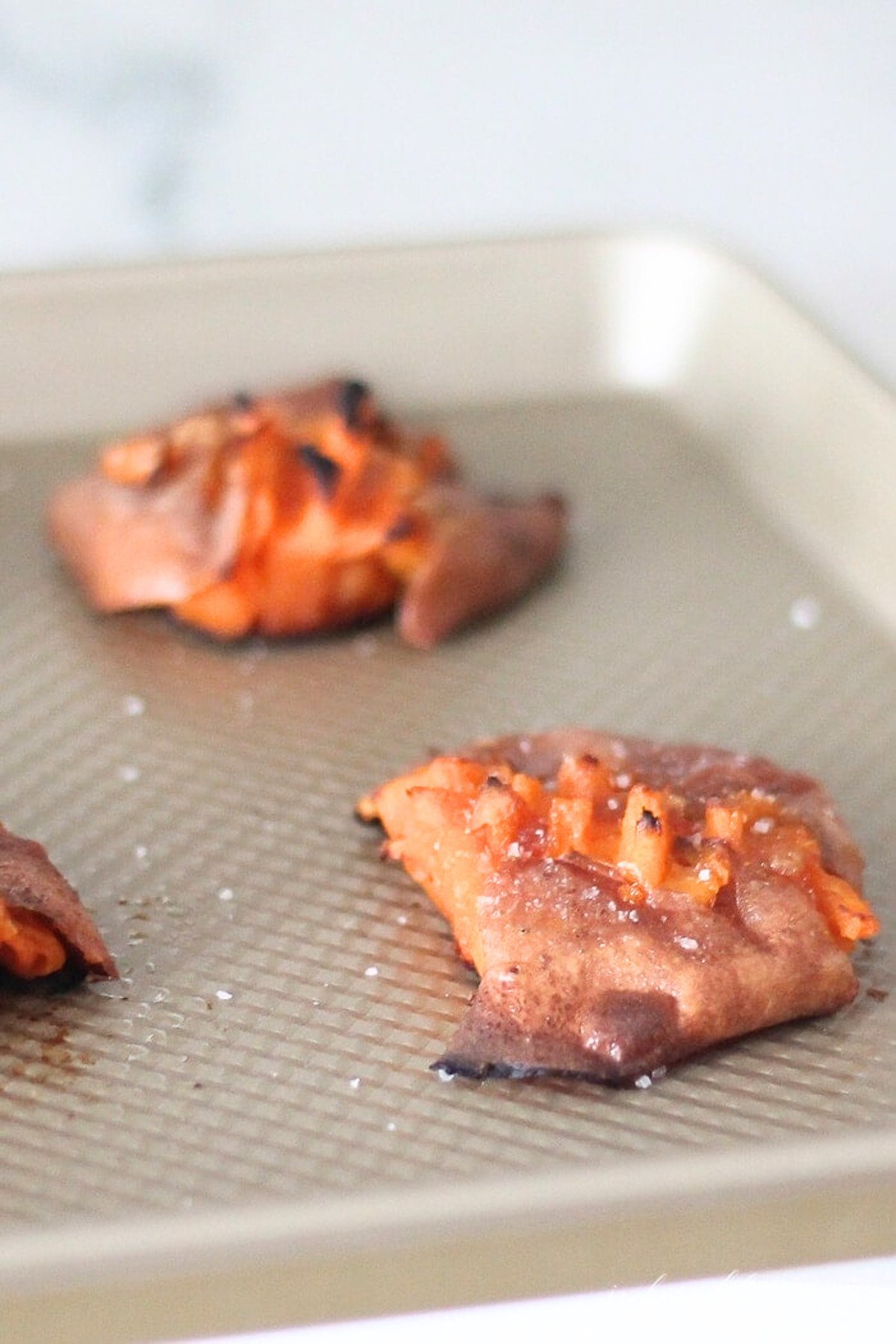 Smashed sweet potato cookies on a baking sheet.