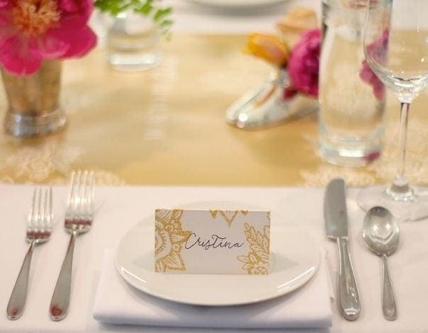 A fake calligraphy name tag on top of a white plate.