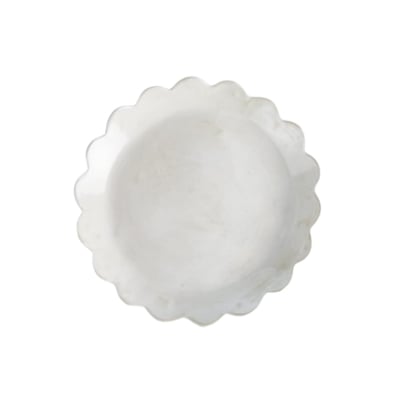 A white scalloped plate on a white background.