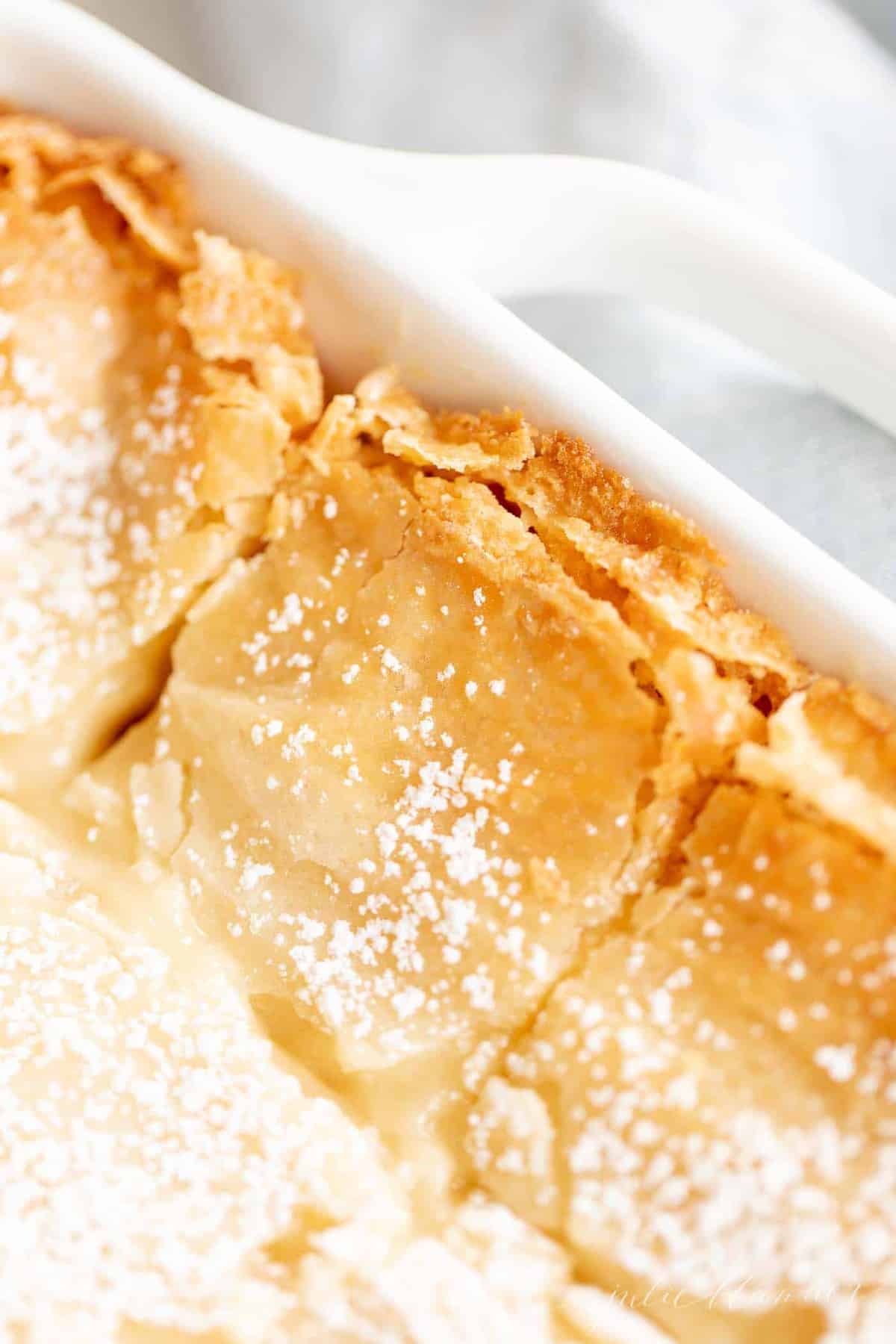 crusty brown butter gooey butter in white baking dish