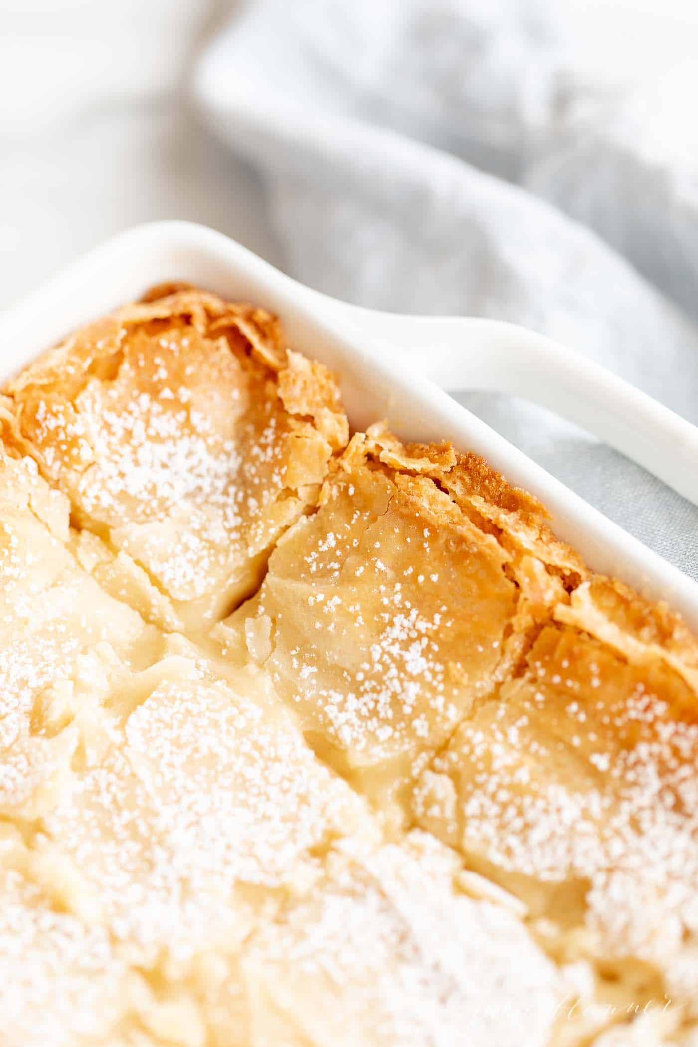 brown butter gooey butter cake on blue napkin