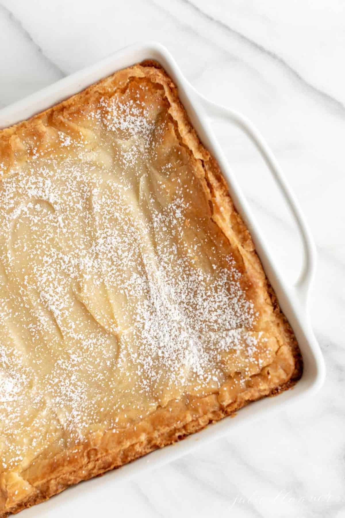 gooey butter cake with brown butter in white baking dish