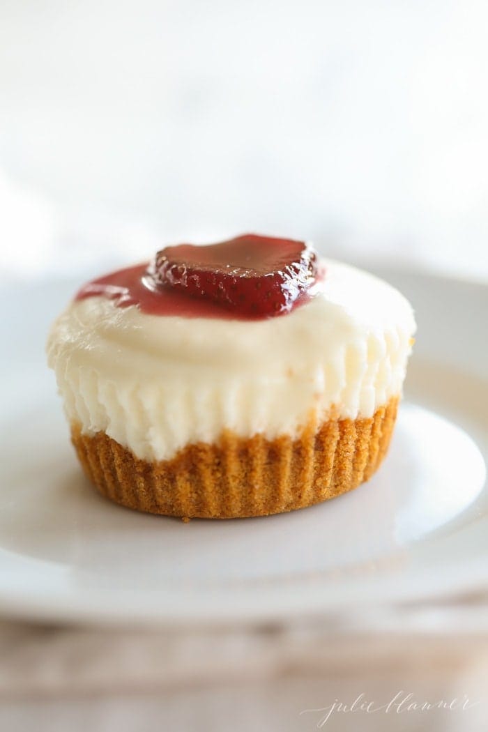 A no bake cheesecake topped with a strawberry and sauce