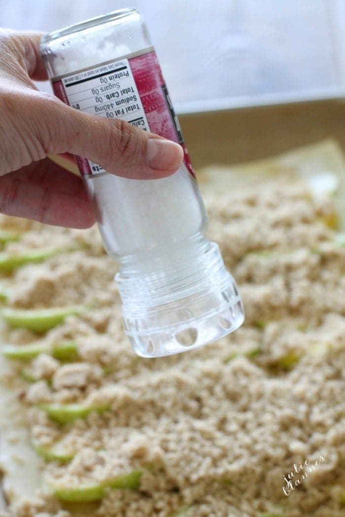 Salt being sprinkled over the top of the apples