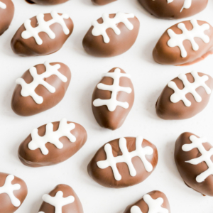 A plate of peanut butter truffles on a white surface.